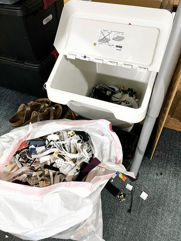 bucket of fabric scraps being emptied into a trash bag
