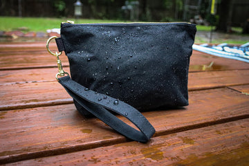 black dry oilskin wristlet with water droplets